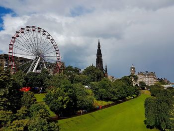 Ferris wheel against cloudy sky