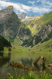 Scenic view of lake and mountains against sky