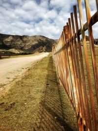 Road by mountain against sky
