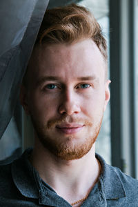 Close-up portrait of smiling mid adult man at home