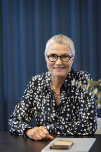 Smiling businesswoman looking at camera