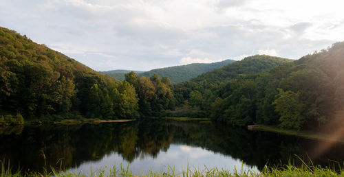 Scenic view of lake and mountains against sky