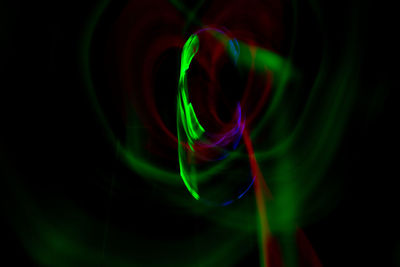 Close-up of light painting against black background