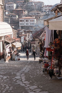 People walking on street at market in city