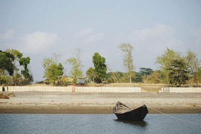 Boat in river against sky