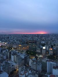 High angle view of illuminated city buildings at dusk