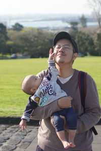 Side view of boy playing with father