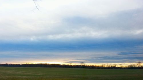 Scenic view of field against sky during sunset