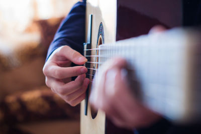 Midsection of person playing guitar