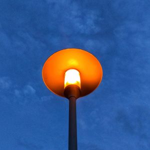 Low angle view of street light against blue sky