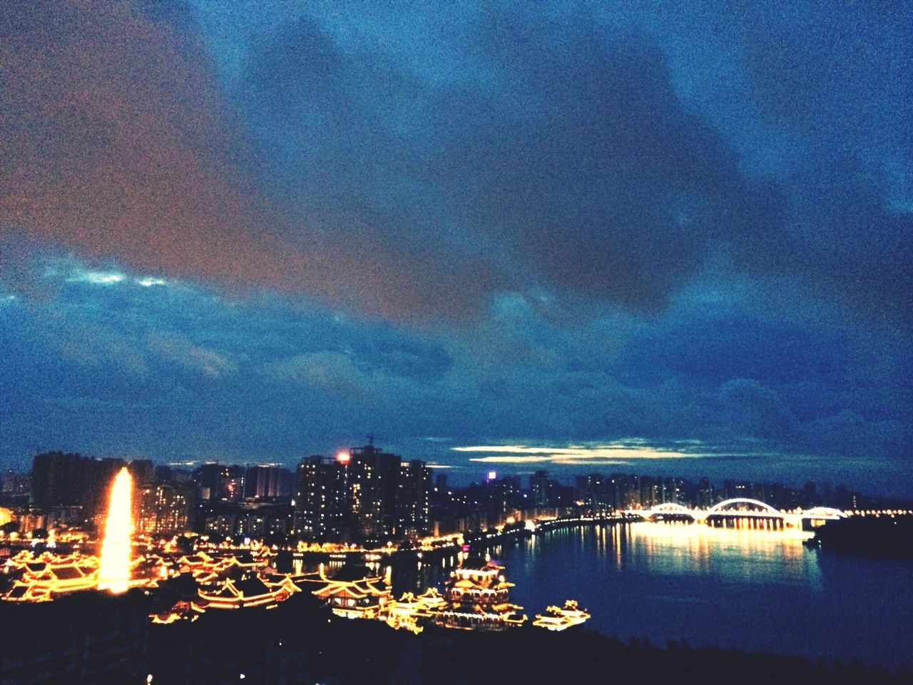 illuminated, water, sky, night, architecture, waterfront, sea, building exterior, built structure, city, cityscape, cloud - sky, river, reflection, harbor, dusk, cloud, outdoors, scenics, blue