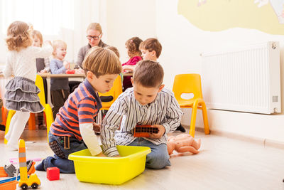 Rear view of people sitting on table