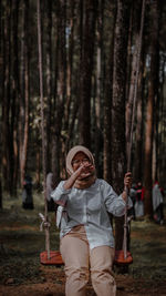 Portrait of girl playing in forest