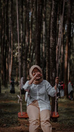 Portrait of boy playing in forest