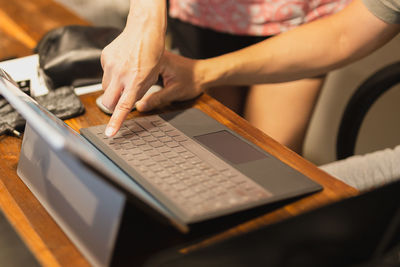 Midsection of man using laptop