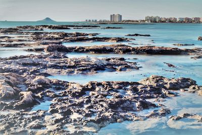 Aerial view of sea and rocks in city