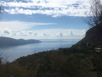 Scenic view of sea and mountains against sky