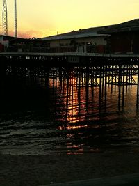 Built structure in water at sunset