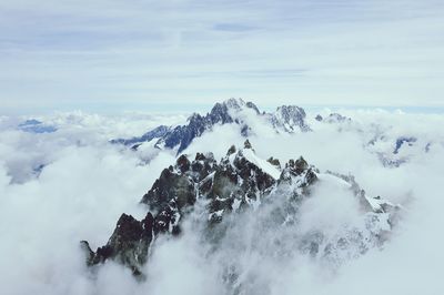 Low angle view of snow mountains against sky