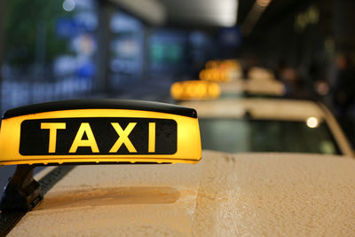 Close-up of yellow sign on car