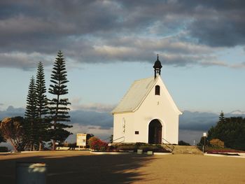 Church by building against sky