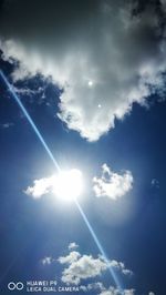 Low angle view of bright sun in sky