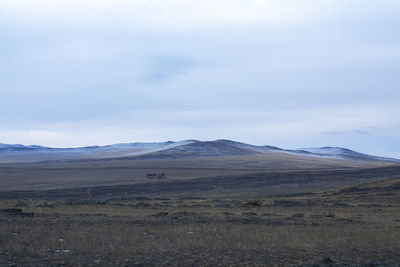 Scenic view of arid landscape against sky