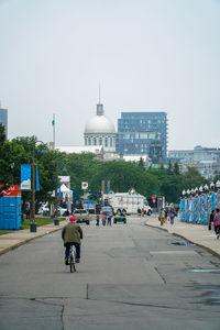 People in city against clear sky