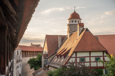 View of medieval town with city wall, half-timbered house and city tower
