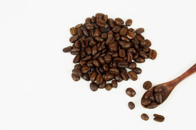 High angle view of coffee beans against white background