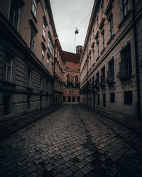 Street amidst buildings in city against sky