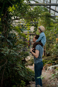 Adventurous family inspecting tropical gallery in botanical garden. local travel