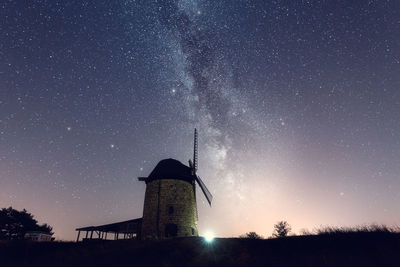 Low angle view of tower against sky at night