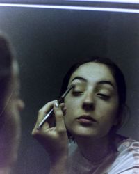 Close-up portrait of a young woman with eyes closed