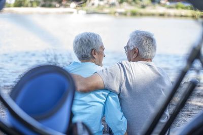 Elderly couple relaxing at waterside