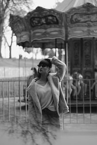 Man looking away while standing against railing