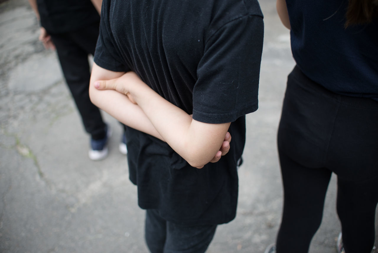 MIDSECTION OF PEOPLE STANDING ON STREET