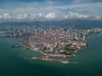 High angle view of sea and buildings against sky