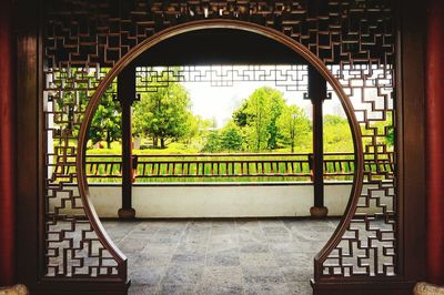 Trees seen through arch window of building