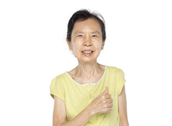 Portrait of a smiling young woman over white background