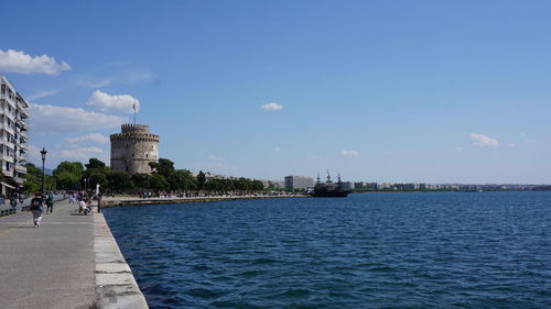 View of sea and buildings against sky