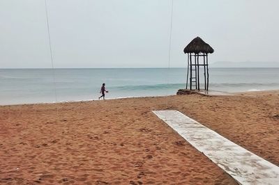 Lifeguard hut on beach against sky