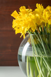 Close-up of yellow flower vase on table