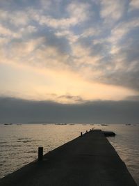 Scenic view of sea against cloudy sky