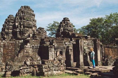 Mid adult woman standing outside ankor wat temple