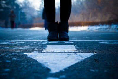 Low section of man standing on ground