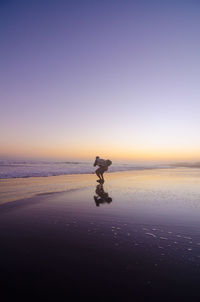 Scenic view of sea against clear sky during sunset