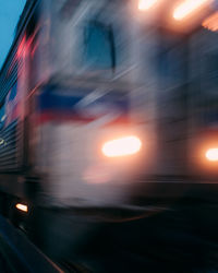 Blurred motion of train on street in city