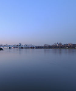 Scenic view of lake against clear blue sky