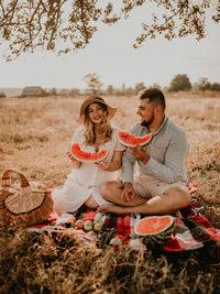 Happy family sitting on field